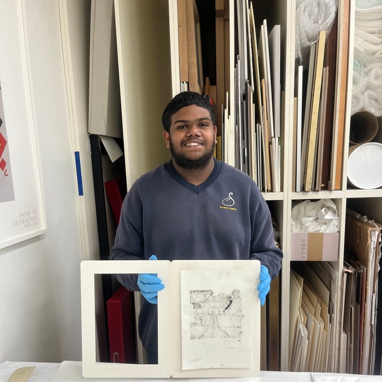 A student proudly displays his work