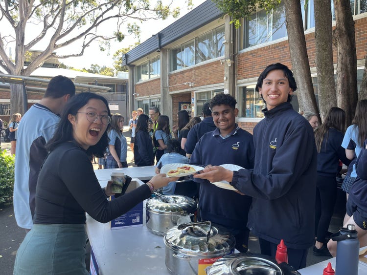 Students serve a teacher at a RISE event.