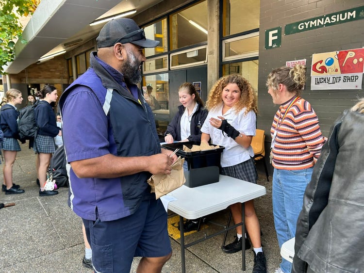 A student talks with two teachers