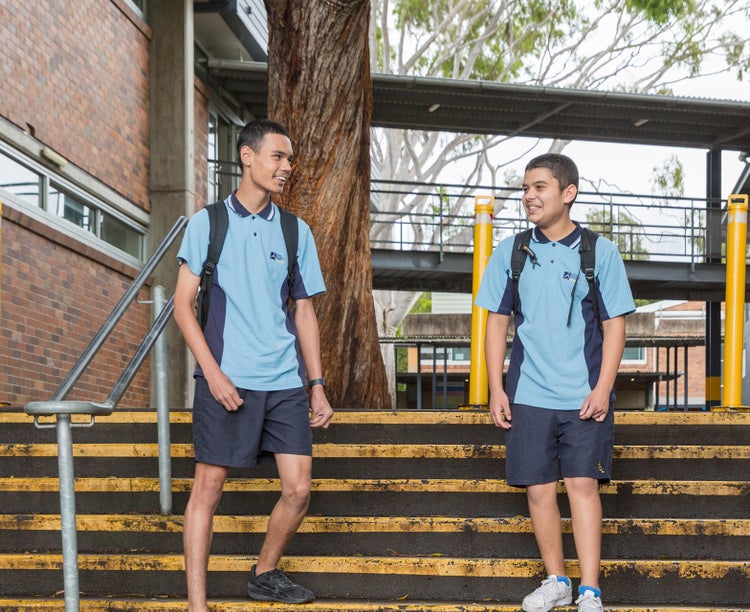 Two students walking down stairs